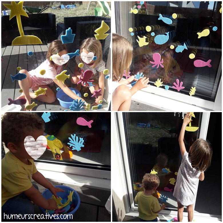 les enfants créent des dessins sur les fenêtres avec les éponges